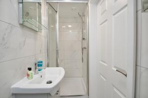 a white bathroom with a sink and a shower at Dane Duplex Studio Two – Cosy Coventry Haven in Coventry