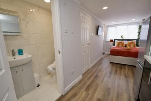 a bathroom with a toilet and a bed in a room at Dane Duplex Studio Four - Stunning Coventry Oasis in Coventry