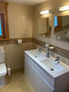 a bathroom with a white sink and a toilet at The Fairways, Kenwick Retreats in Louth