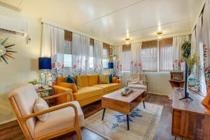 a living room with a yellow couch and chairs at Pet-Friendly Brownwood Home Walk to Lake! in Lake Brownwood
