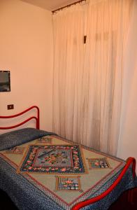 a bedroom with a bed with a rug on it at Appartamenti Pian d'Alma in Punta Ala