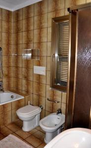 a bathroom with a toilet and a sink at Appartamenti Pian d'Alma in Punta Ala