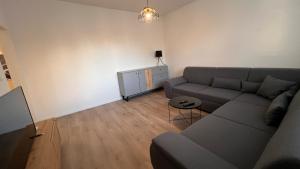 a living room with a couch and a table at Air conditioned 3 room apartment, near Technopol in Bratislava