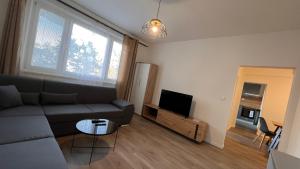 a living room with a couch and a flat screen tv at Air conditioned 3 room apartment, near Technopol in Bratislava