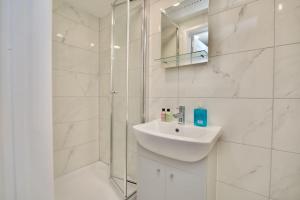 a white bathroom with a sink and a shower at Dane Duplex Studio Five - Dashing Coventry Home Away From Home in Coventry