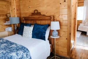 a bedroom with a bed with blue pillows and two lamps at Snow Valley Hideaway Arrowbear Lake Retreat in Arrowbear Lake