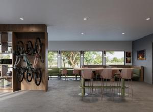 a dining room with a table and chairs and windows at LOGE Missoula in Missoula