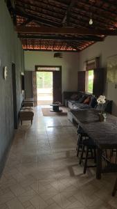 Village por do sol في أراكاجو: غرفة معيشة مع أريكة وطاولة