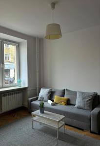 a living room with a couch and a coffee table at Apartament K3 in Warsaw