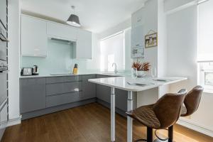 cocina con mesa blanca y 2 sillas en Charming 1 Bedroom Serviced Apartment in Camden, en Londres