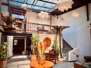 ein Zimmer mit einem Tisch und einigen Pflanzen und einer Treppe in der Unterkunft Hotel Quinta Bolivar in Bogotá