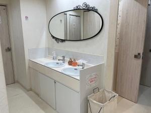 a bathroom with a sink and a mirror at Cafe&Hostel Kimi to Ichigo in Osaka +20 photos