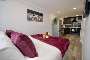 a bedroom with a white bed with a purple blanket on it at Dane Duplex Studio Seven - Your Dream Coventry Stay in Coventry