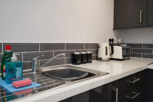 a kitchen counter with a sink and a microwave at Dane Duplex Studio Seven - Your Dream Coventry Stay in Coventry