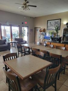 a dining room with tables and chairs and a kitchen at Super 8 by Wyndham Sullivan in Sullivan