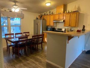 a kitchen and dining room with a table and a refrigerator at Pomona in Chico