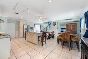 a kitchen and dining room with a table and chairs at Tiki Blue in Cocoa Beach