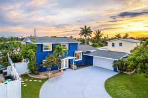 a blue and white house with a driveway at Tiki Blue in Cocoa Beach