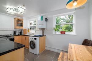 a kitchen with a washer and dryer at Quiet 4 Bedroom House between Camden & Kings Cross in London