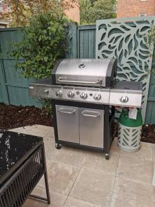 a grill sitting on a patio in a backyard at Quiet 4 Bedroom House between Camden & Kings Cross in London