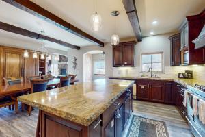 a large kitchen with wooden cabinets and a large island at Black Bear Lodge in Eagle