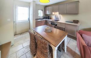 a kitchen with a wooden table and chairs at Gorgeous Home In Saint-Laurent-De-La-Ca in Saint-Laurent-de-la-Cabrerisse