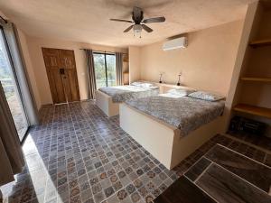a bedroom with two beds and a ceiling fan at Xbalche eco hotel & RV park 