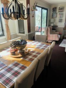 a dining room table with a plaid table cloth at Mountain Retreat Suitable for 2 Families, Sleeps 8 in Mount Buller