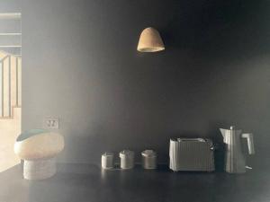 a bathroom with a toilet and a light on the wall at The Base at Byron in Suffolk Park