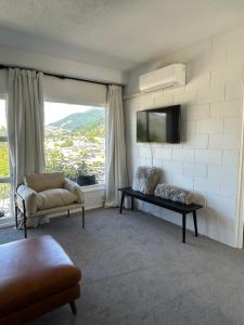 a living room with a couch and a tv at Wee Dram in Queenstown