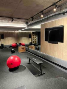 a room with a bowling alley with balls and a flat screen tv at More Echevarriarza apartamento de estreno!! in Montevideo