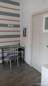 una silla blanca sentada en una habitación con una pared en Turin Little House, en Turín