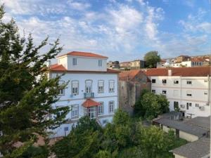 a white building with a red roof in a city at Apartament Praceta Vila do Conde in Vila do Conde