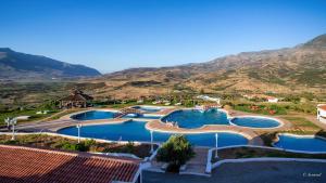 an aerial view of a resort with two pools at Hotel El Cortijo & SPA in Chefchaouene