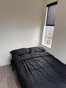 a bed in a white room with a window at Private Apartment in Portland in Portland