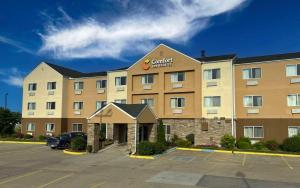 a hotel with a car parked in a parking lot at Comfort Inn & Suites Coralville - Iowa City near Iowa River Landing in Coralville