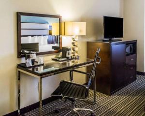 a hotel room with a desk and a chair at Quality Inn Streetsboro in Streetsboro