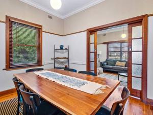 a dining room with a wooden table and chairs at 'YANALEN COTTAGE' in Myrtleford