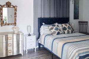 a bedroom with a bed with a mirror and a dresser at The Pool House in Charlotte +10 photos