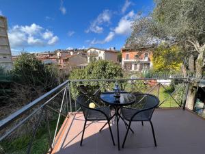 a patio with two chairs and a table on a balcony at Casa Rodella -SUITE- San Sisto Perugia in Perugia