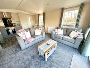 a living room with two couches and a coffee table at Lone Star Lodge in Morpeth