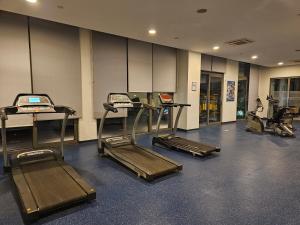 a gym with treadmills and ellipticals in a room at TAKSiM PERFECT RESiDENCE, 3 BEDROOMS, 140 M2, POOL GYM SAUNA ACCESS in Istanbul
