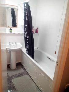 a bathroom with a sink and a bath tub next to a sink at Cosy furnished double room in a great quiet location walking distance to seaside and town in Kent