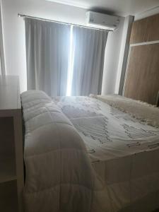 a bed in a room with a window and a white mattress at Cerca Trova in San Rafael