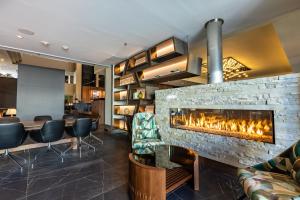 a lobby with a fireplace and a bar at Renaissance Denver Hotel & Conference Center in Denver
