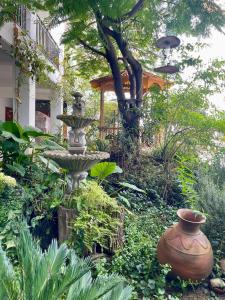 a fountain in the middle of a garden at El Oasis de Dorita in Caraz