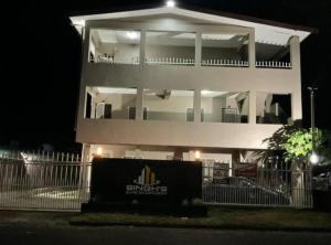 a white building with a sign in front of it at night at Singhs elite apartment in Nadi