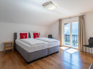 a bedroom with a bed and a large window at Villa Taube XL in Bad Gastein