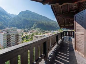 a balcony with a view of a city and mountains at Villa Taube XL in Bad Gastein