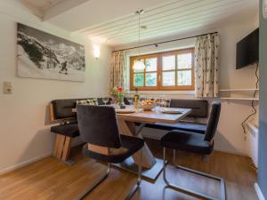 a dining room with a table and chairs at Villa Taube XL in Bad Gastein